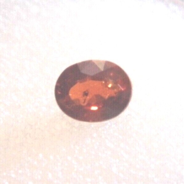 Spessartite (Oval 5.5×4.5×2.5mm) .63cts. Slightly Included Beautiful Cut!