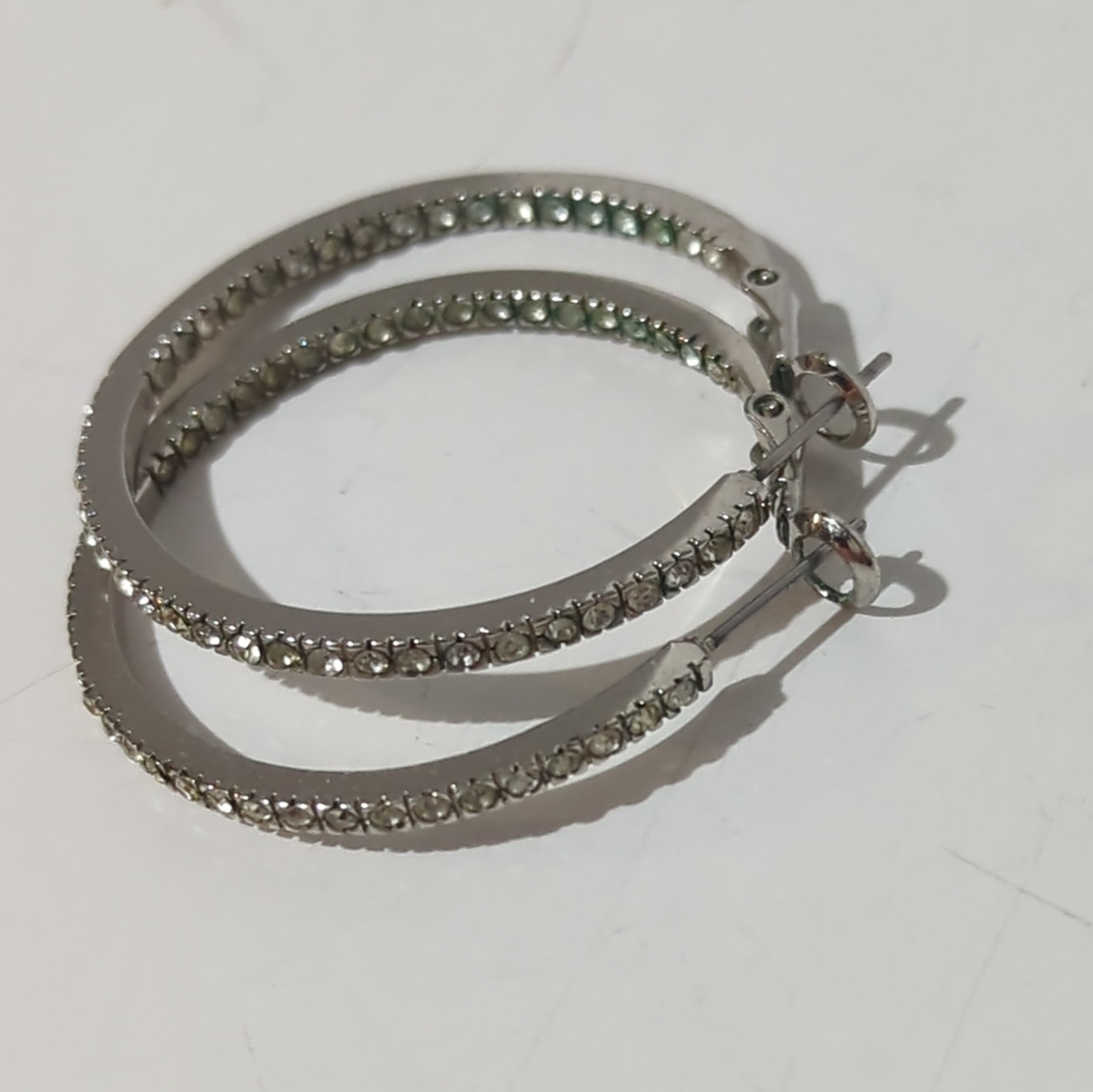 Touchstone Crystal by Swarovski Silver Tone Inside-Out Clear Pavé Hoop Earrings