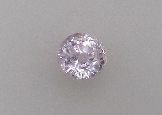 0.86 Carat Light Pink Sapphire, 4.5 mm Round, Very Slightly Included. COA.