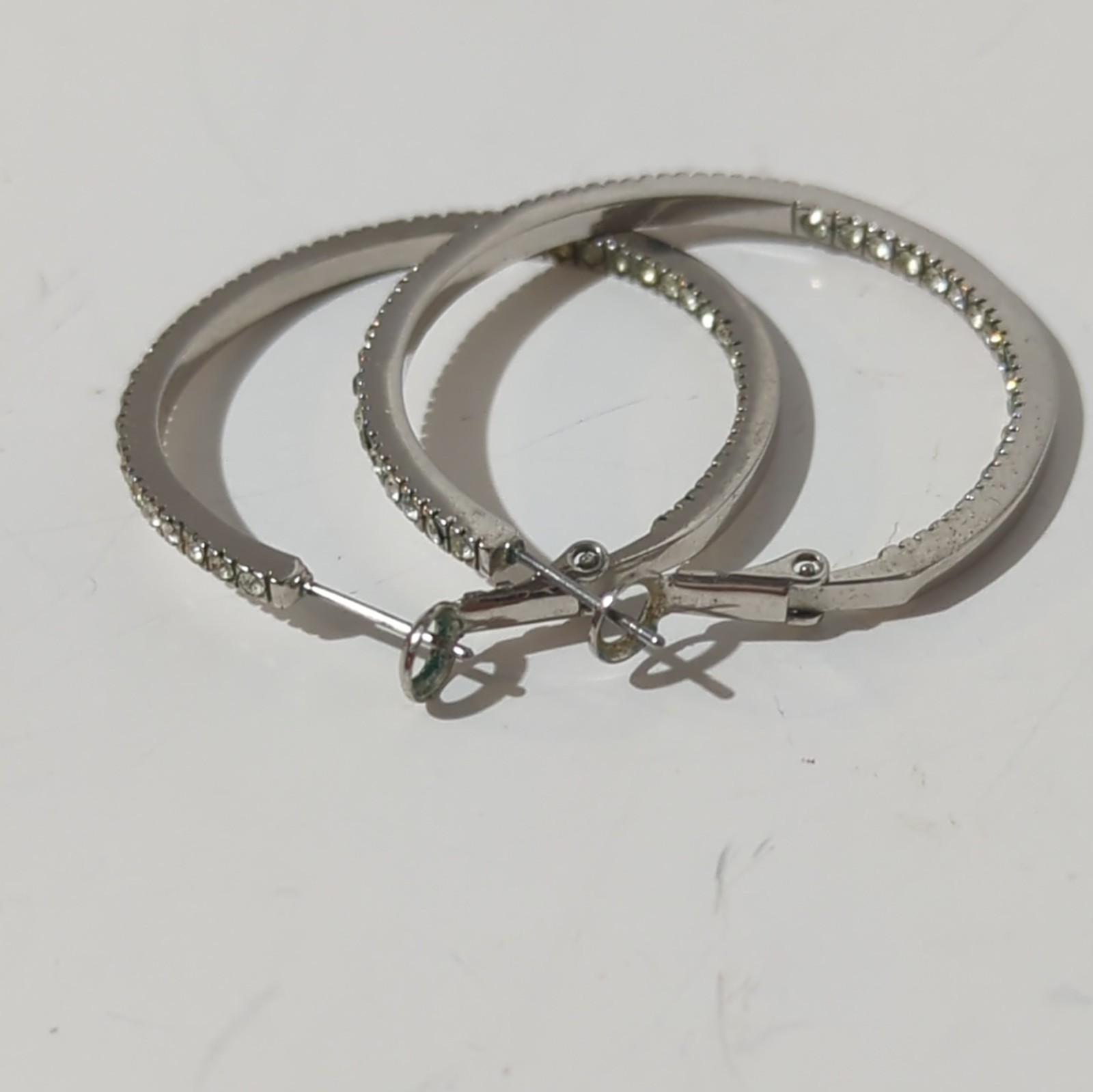 Touchstone Crystal by Swarovski Silver Tone Inside-Out Clear Pavé Hoop Earrings