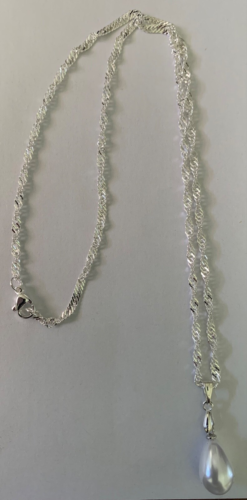 18″ Stainless Steel Chain with a White Glass Teardrop Pearl Pendant