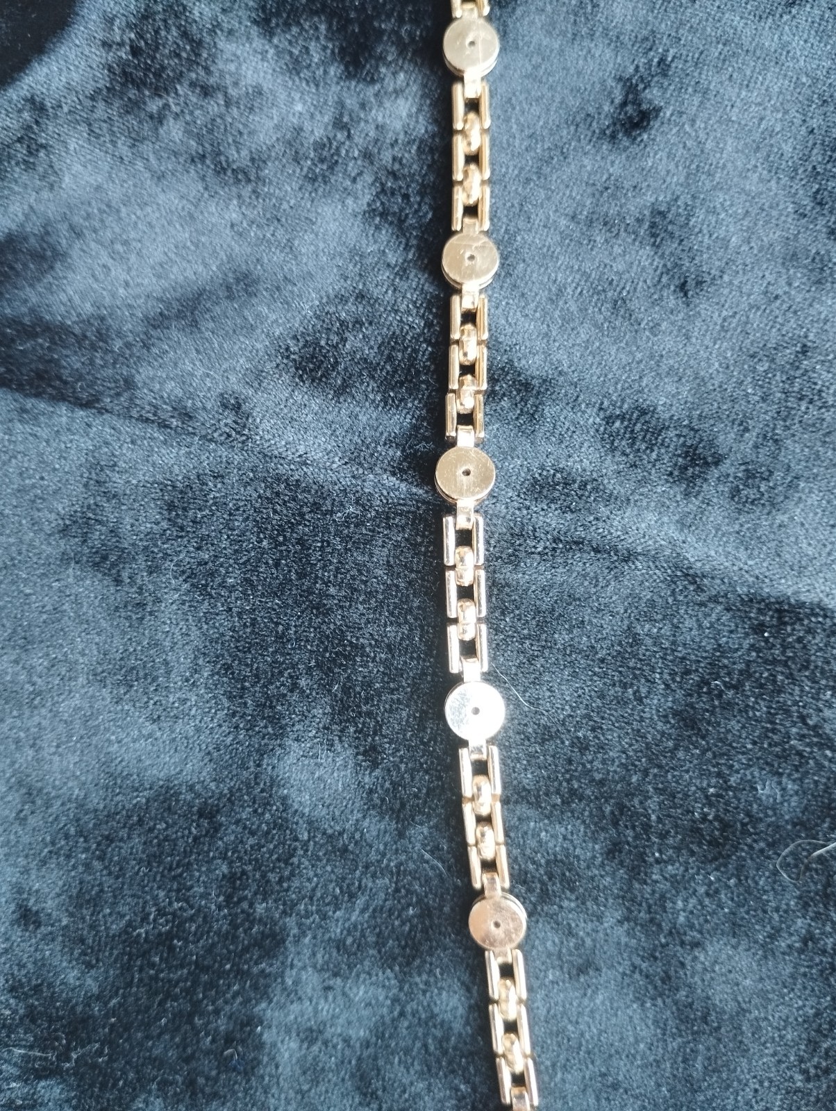 Gold-colored bracelet.