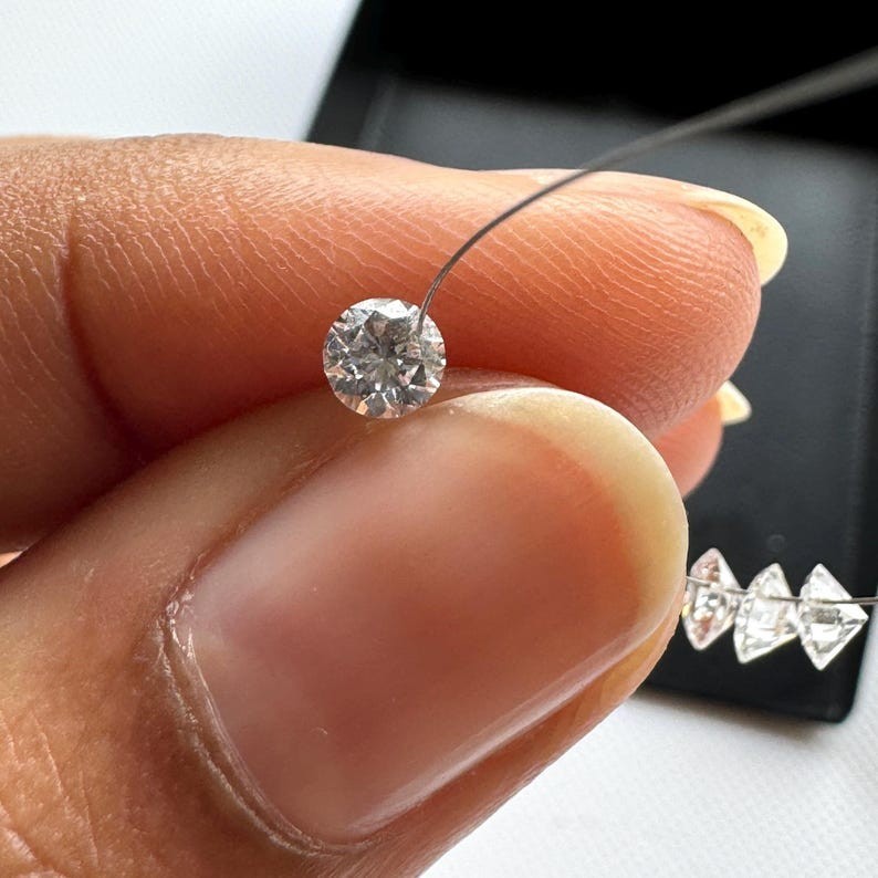 0.60tcw 6pcs EF Color Drilled Round Cut Lab Grown Diamond for Jewelry Creation.
