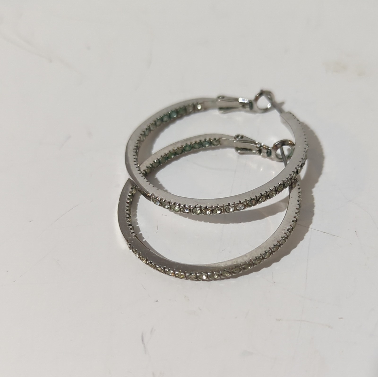 Touchstone Crystal by Swarovski Silver Tone Inside-Out Clear Pavé Hoop Earrings