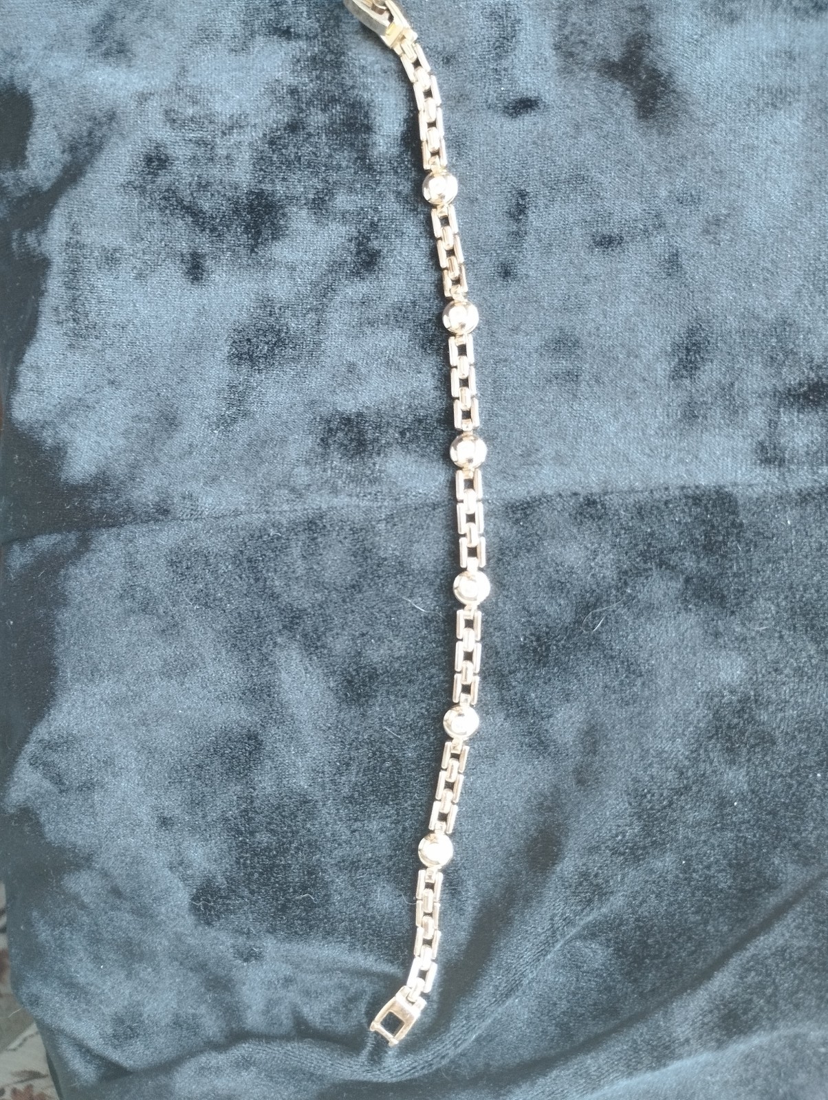 Gold-colored bracelet.
