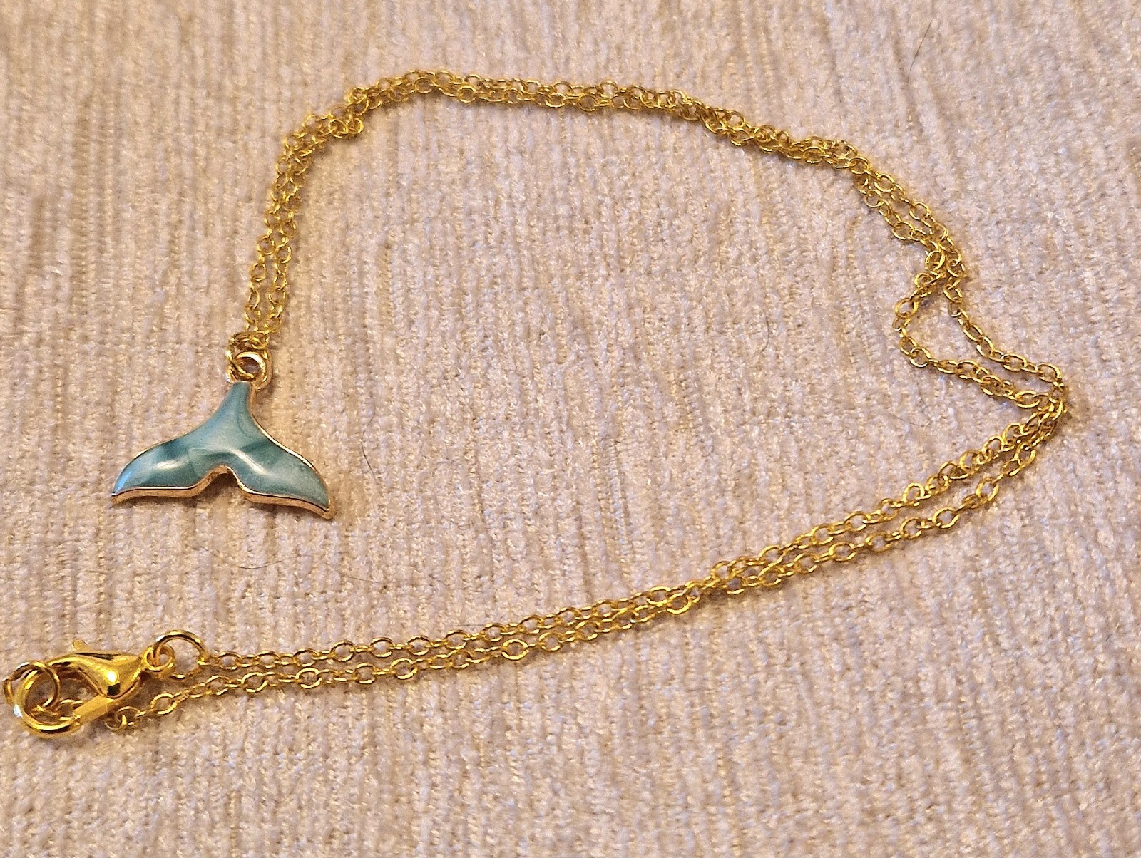 Pretty blue whales tail charm necklace on 16 inch gold plated chain, good luck