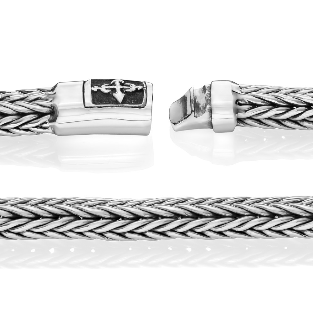 Sleek silver cross bracelet blending faith and modern style for everyday wear.