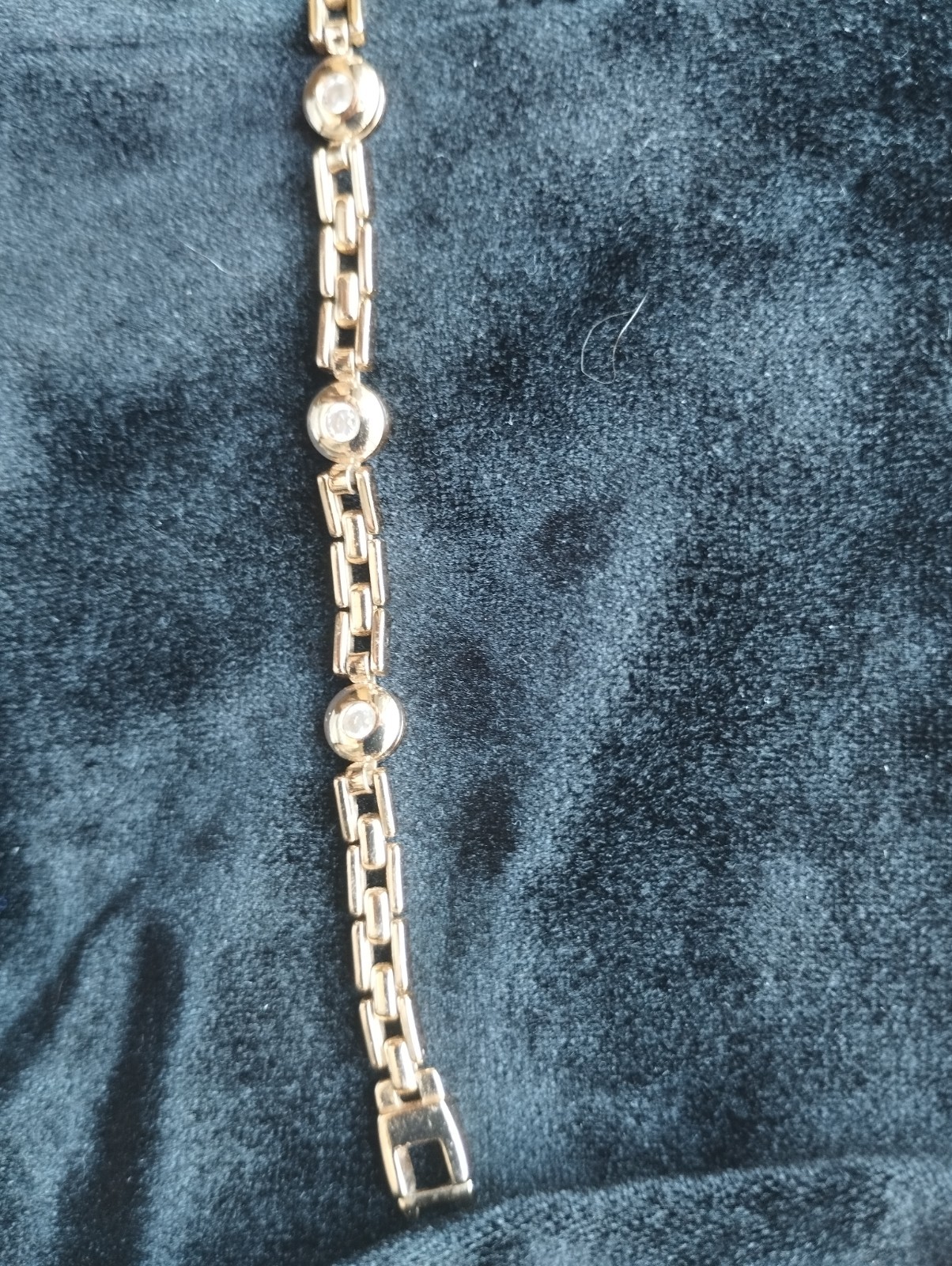 Gold-colored bracelet.